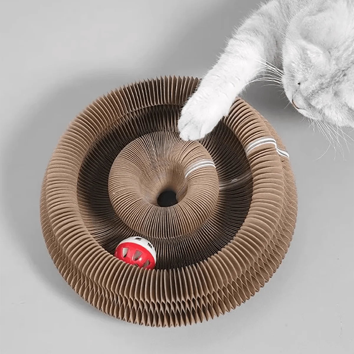 Transformable accordion cat scratcher and ball track by Furvio Shop, featuring colorful, foldable design with scratching surfaces and ball toys.