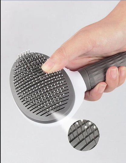 Self-cleaning Furvio Shop pet grooming brush with ergonomic handle and stainless steel bristles for easy fur removal.