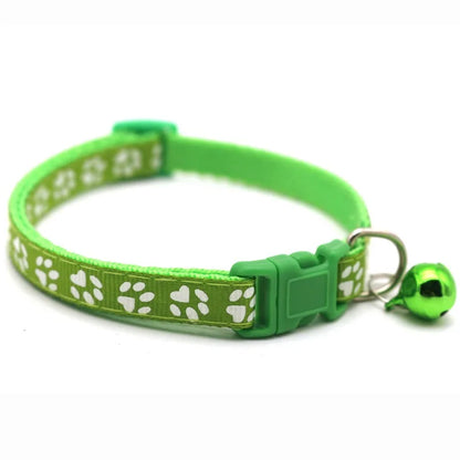 Reflective paw print breakaway collar for pets, featuring a safety buckle and Furvio Shop branding, shown in close-up detail.