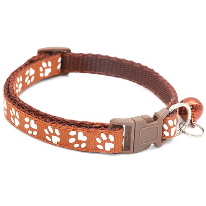 Reflective paw print breakaway dog collar by Furvio Shop with adjustable strap and safety buckle, featuring a colorful paw print pattern.