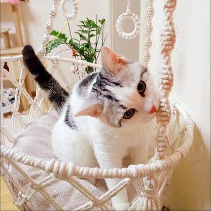 Hand-woven boho cat hammock swing by Furvio Shop featuring a cozy, macrame design perfect for feline relaxation.