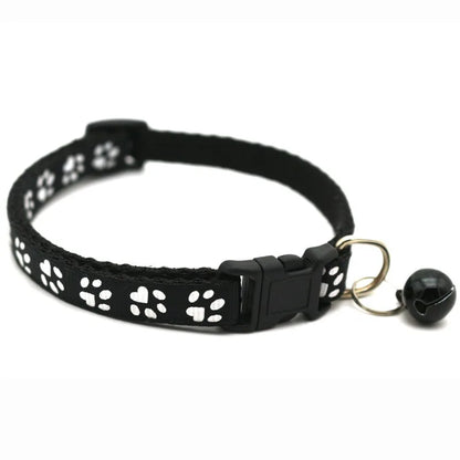 Reflective paw print breakaway dog collar by Furvio Shop with adjustable strap and safety buckle on a white background.