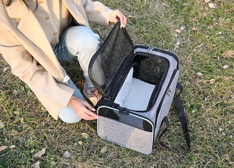Expandable breathable pet carrier bag by Furvio Shop showing mesh panels, zipper opening, and padded handles for comfortable carrying.