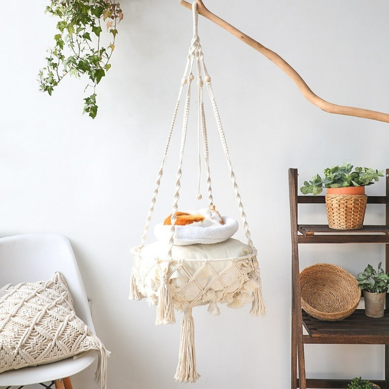 Hand-woven boho cat hammock swing by Furvio Shop featuring macrame design and cozy fabric for feline comfort.